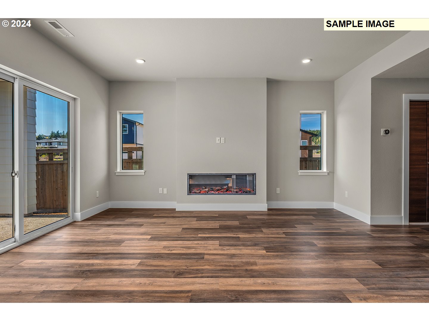 12343 Southeast Falling Rain Way Happy Valley, OR 97086 - Photo 5 of 39 an empty room with wooden floor and windows