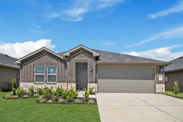 a front view of a house with a garden and plants