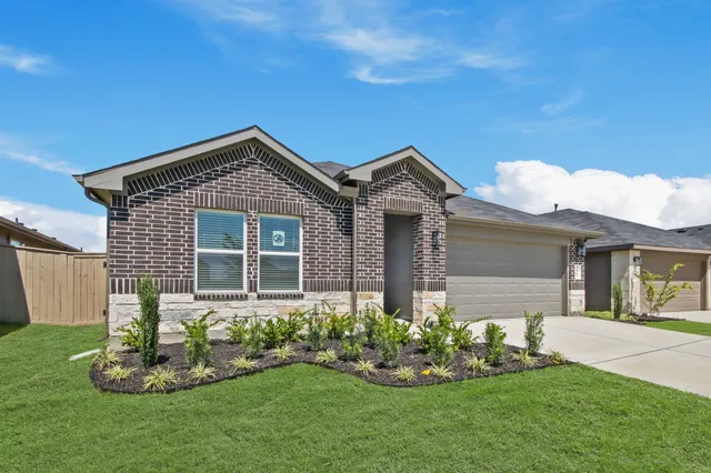 a front view of house with a garden