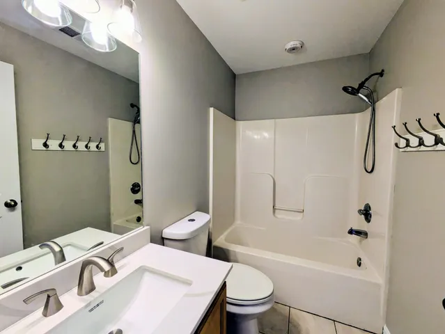 a white toilet sitting next to a bath tub