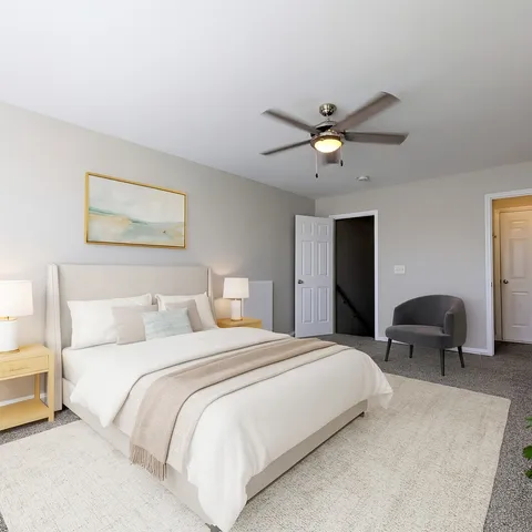 a bedroom with bed and a chandelier