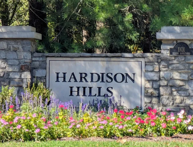 a sign that is in front of flowers