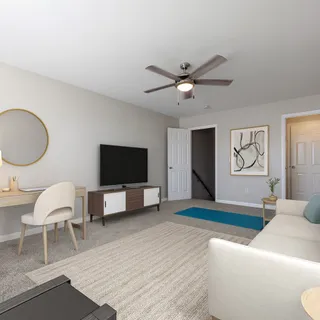 a living room with furniture a flat screen tv and kitchen view