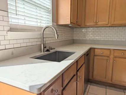 a kitchen with a sink and cabinets