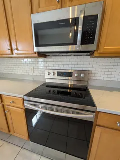 a stove top oven sitting inside of a kitchen