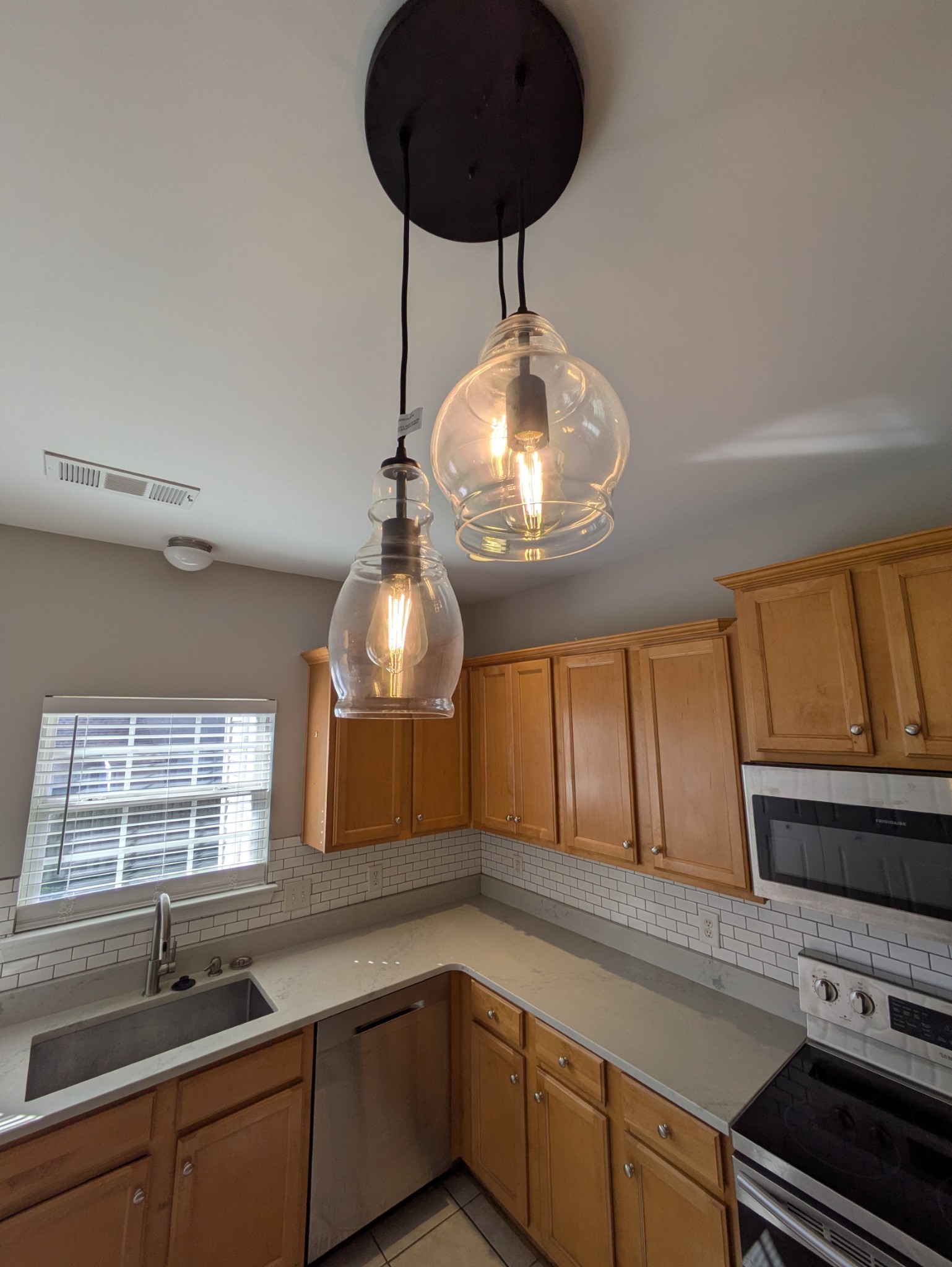 1101 Downs Boulevard, Unit 267 Franklin, TN 37064 - Photo 29 of 36 a kitchen with a sink and chandelier