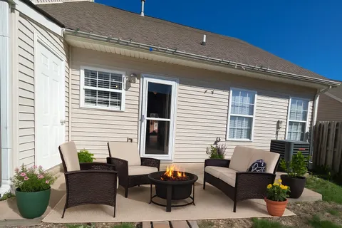 a view of a patio with couches table and chairs and potted plants