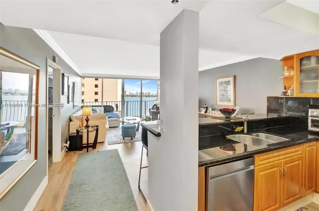 a dining room with furniture a chandelier and wooden floor