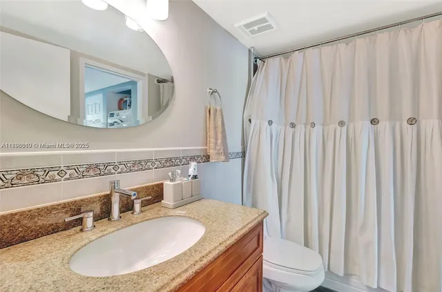 a view of a hallway with wooden floor and closet