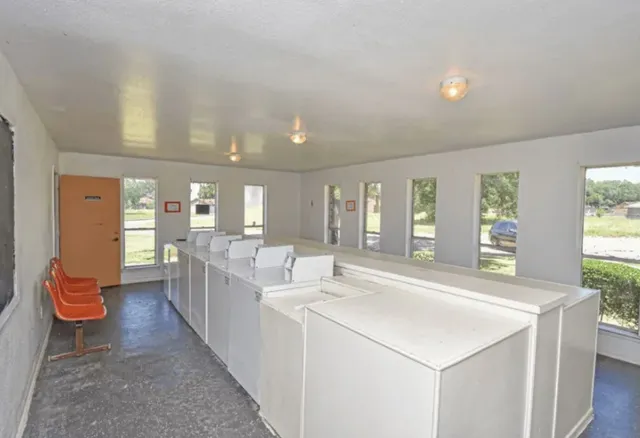 a large white kitchen with a large window
