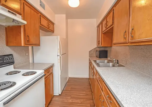 a kitchen with a stove and a refrigerator