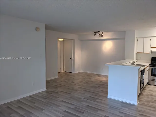 a kitchen with granite countertop a stove and a refrigerator