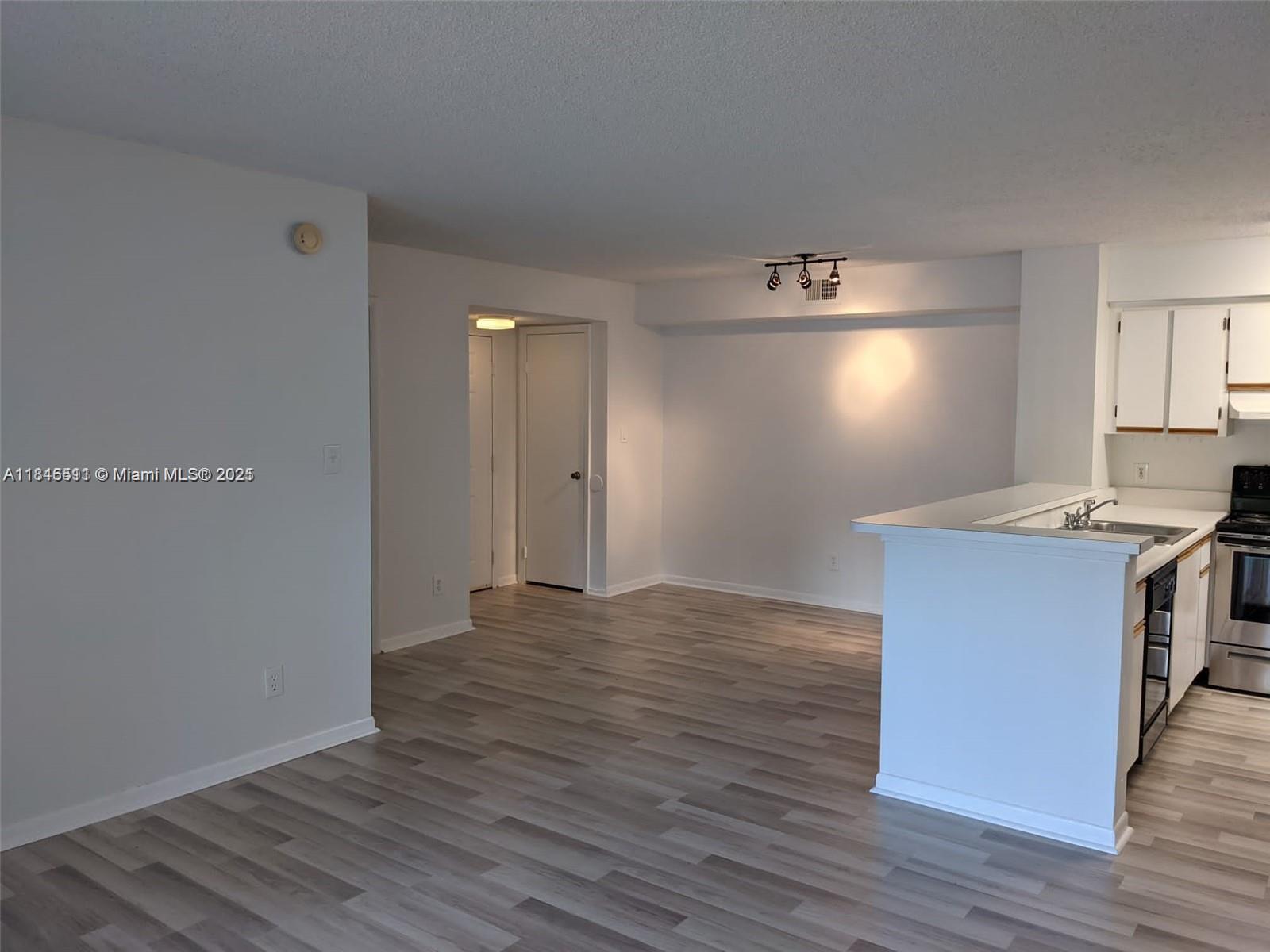 a kitchen with granite countertop a stove and a refrigerator