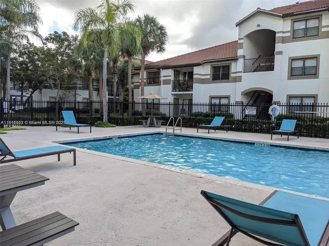 a view of a patio with swimming pool