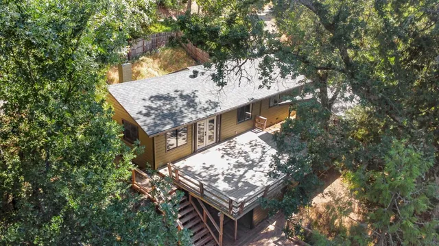 an aerial view of a house with a yard