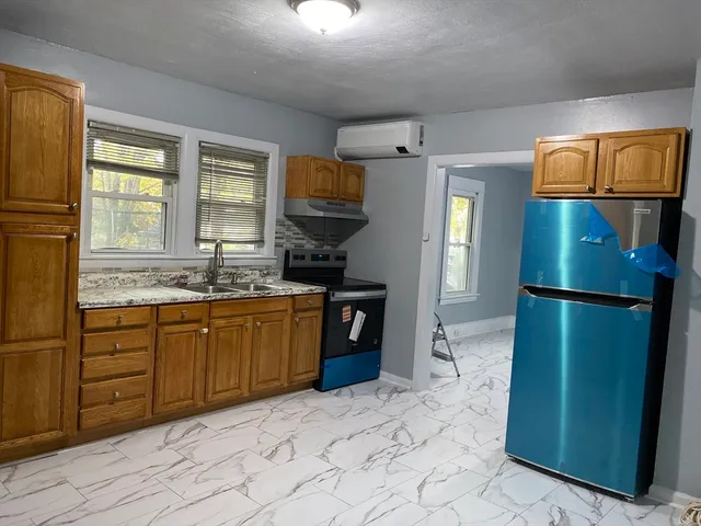 a kitchen with a refrigerator and a sink