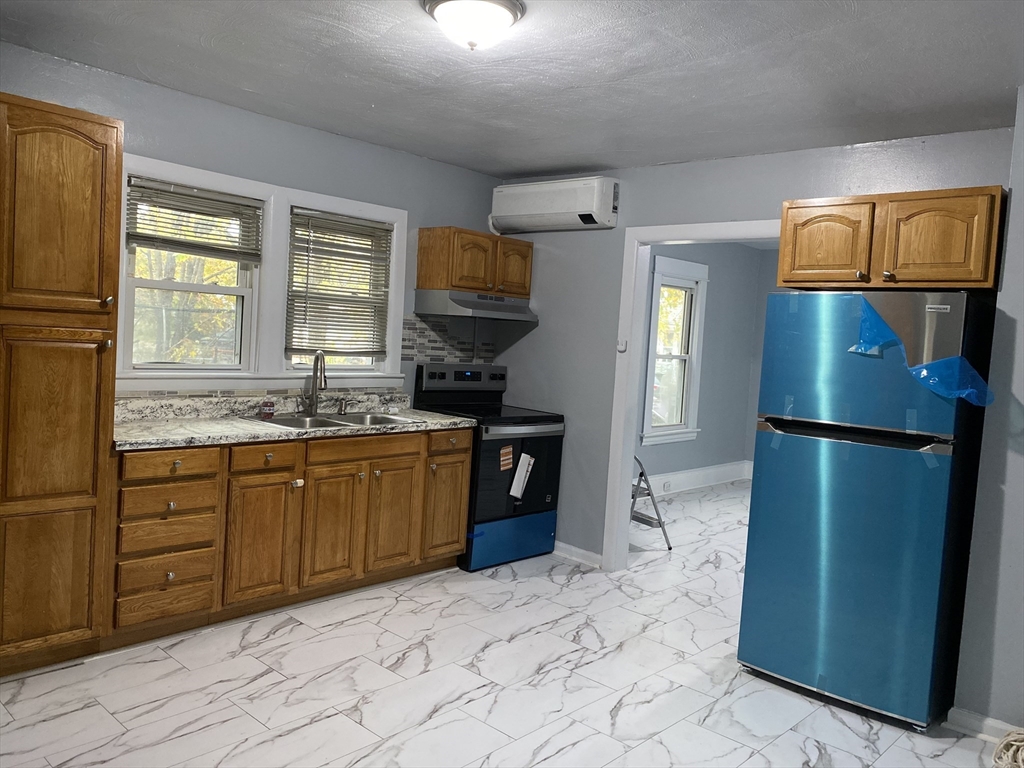 a kitchen with a refrigerator and a sink