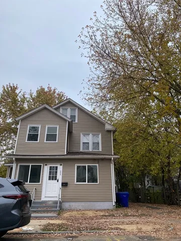 a front view of a house with a garden