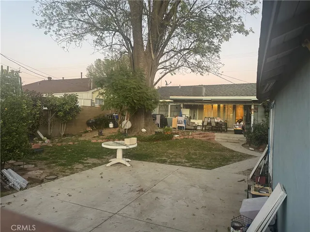 a view of a house with backyard sitting area and garden