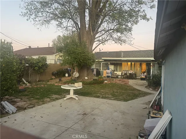 a front view of a house with swimming pool table and chairs