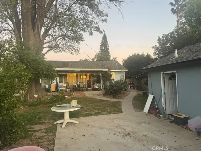 a view of a house with backyard porch and sitting area