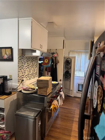 a kitchen with a refrigerator and a stove