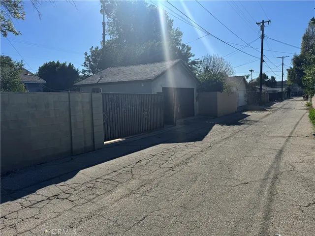 a bedroom with a bed and a large mirror