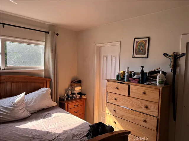a bedroom with a bed and a dresser