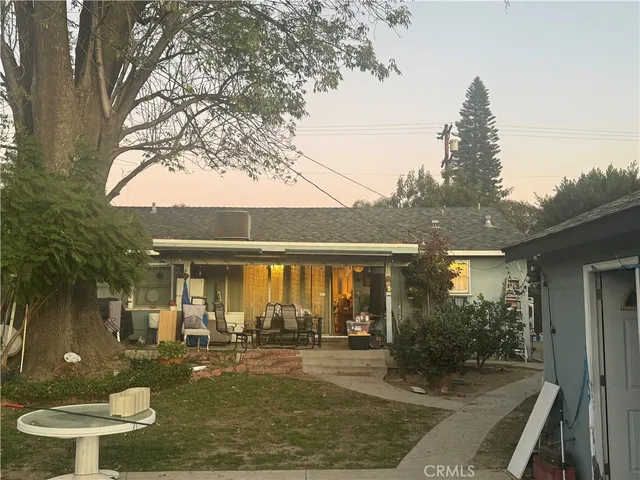 a view of a house with backyard porch and sitting area