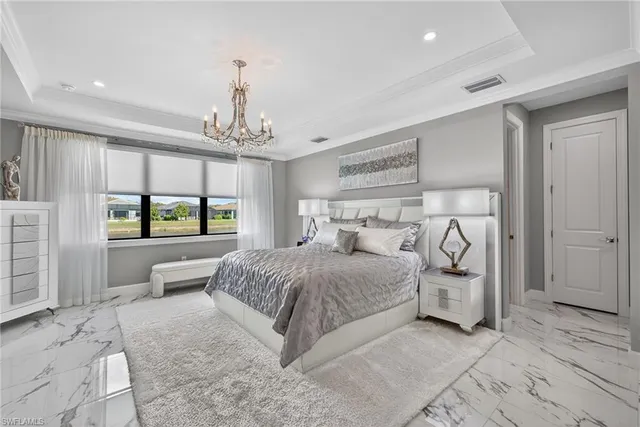 a living room with furniture a chandelier and a dining table