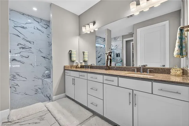 a spacious bathroom with a granite countertop sink a mirror and a