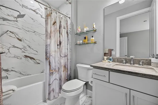 a bedroom with a bed and flat screen tv