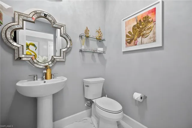 a bathroom with a sink toilet vanity and shower