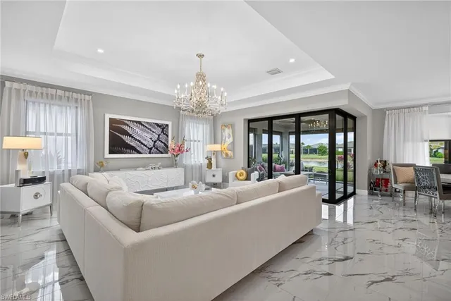 a living room with furniture and a chandelier