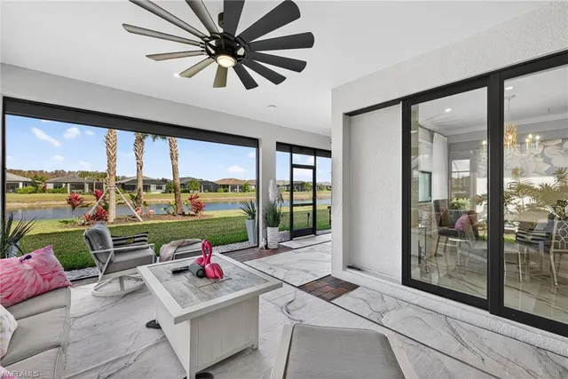 a living room with patio furniture and a large window