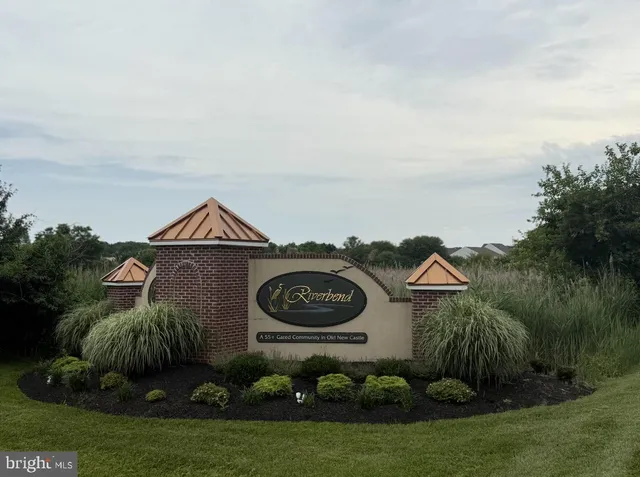 a kitchen with stainless steel appliances granite countertop a sink a stove and chairs