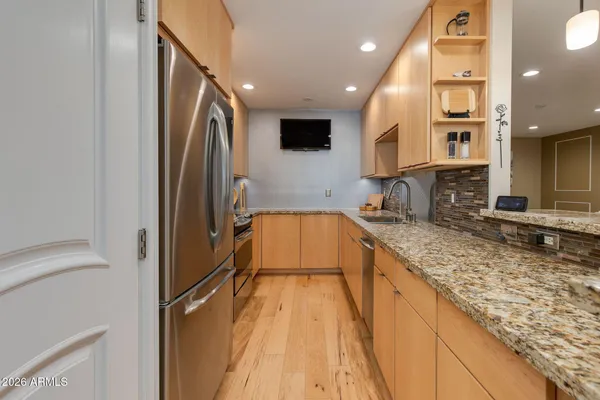 a living room with kitchen island granite countertop furniture and a kitchen view