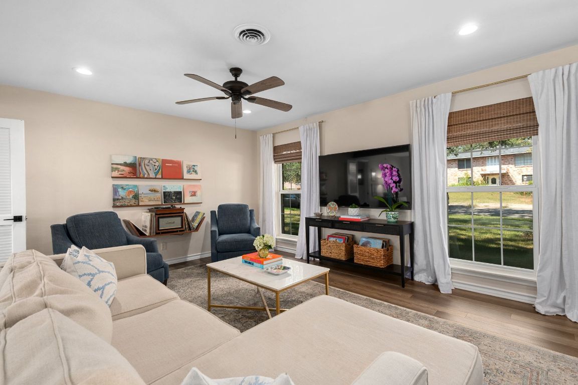 5605 Exeter Drive Austin, TX 78723 - Photo 11 of 32 a living room with furniture a flat screen tv and a fireplace