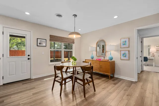 a view of a dining room with furniture window and wooden floor