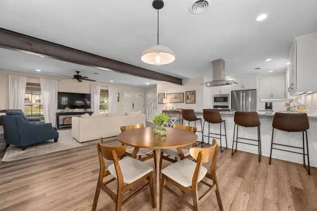 a view of a dining room with furniture and wooden floor