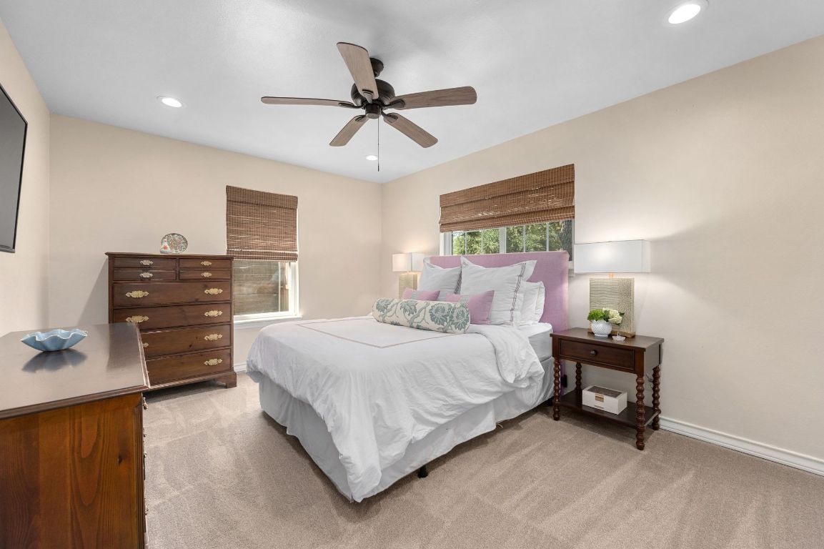 5605 Exeter Drive Austin, TX 78723 - Photo 19 of 32 a bedroom with a bed and a chandelier