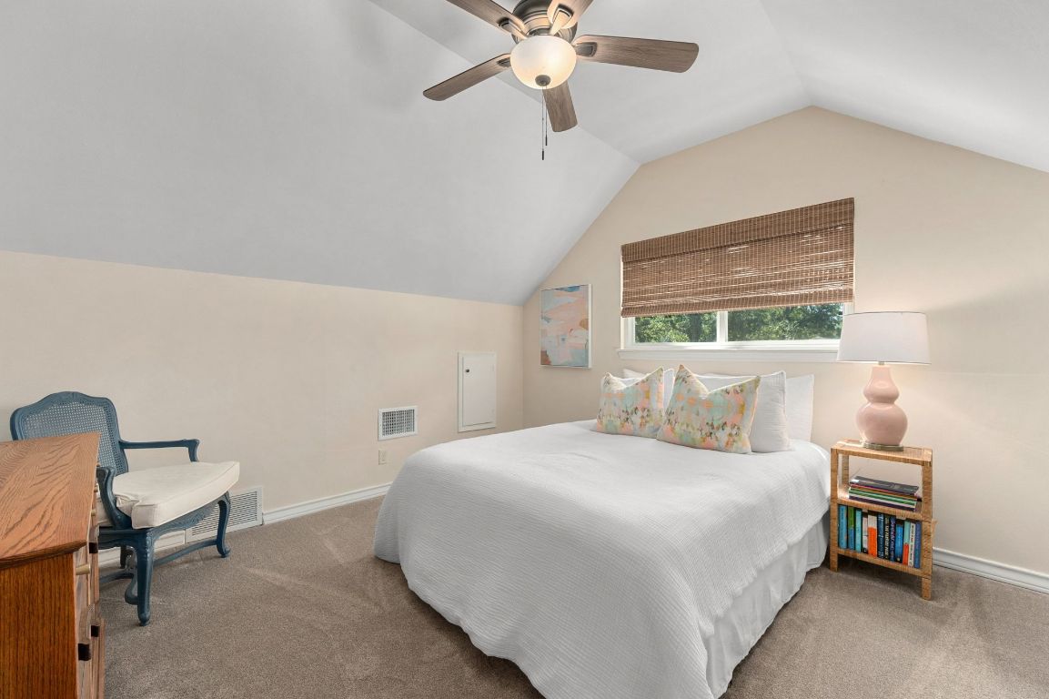 5605 Exeter Drive Austin, TX 78723 - Photo 27 of 32 a bedroom with a bed and a chandelier