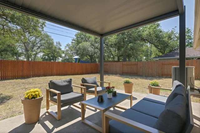 a view of a patio with couches chairs and a potted plant
