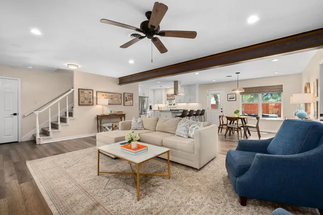 a living room with furniture ceiling fan and a rug