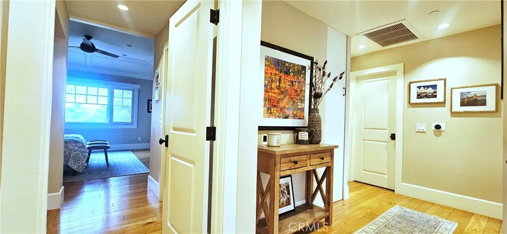 33925 Cape Cove Dana Point, CA 92629 - Photo 20 of 50 a view of a hallway with wooden floor and a bathroom