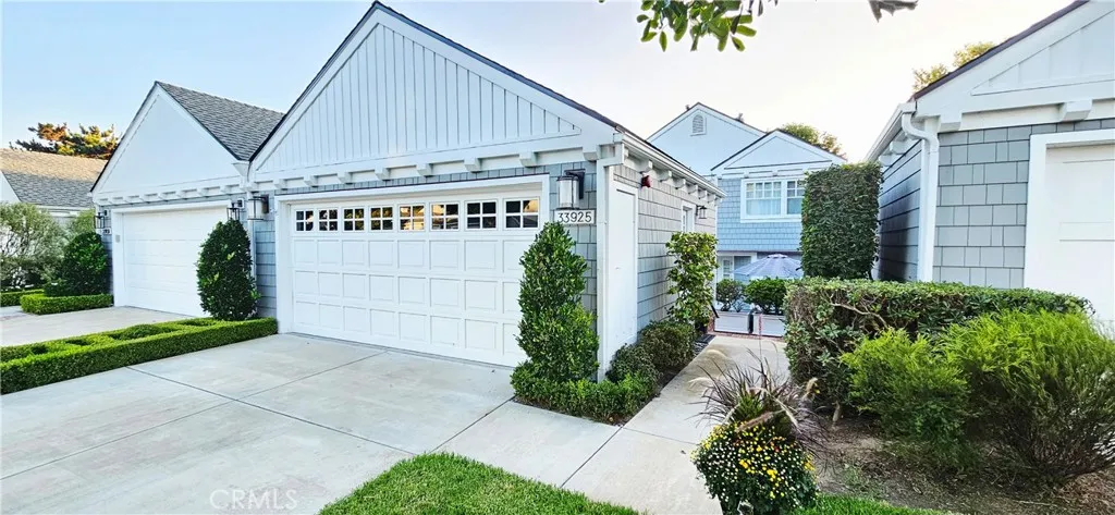 33925 Cape Cove Dana Point, CA 92629 - Photo 3 of 50 a view of a white house next to a yard with potted plants
