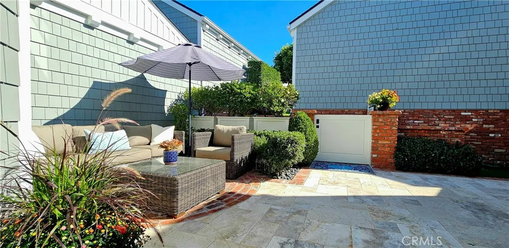 33925 Cape Cove Dana Point, CA 92629 - Photo 5 of 50 a view of a patio with couches table and chairs under an umbrella