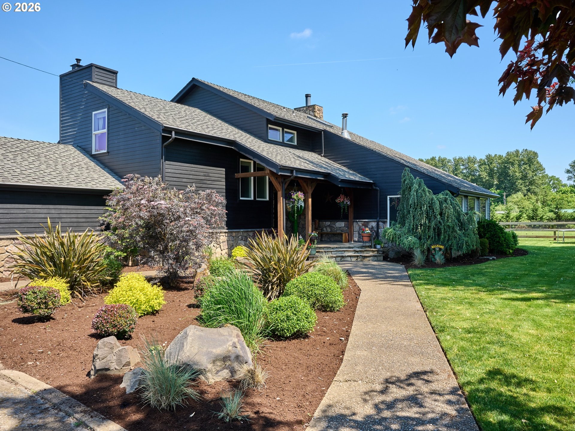 9293 Broadacres Road Northeast Aurora, OR 97002 - Photo 3 of 48 a front view of a house with a yard and potted plants