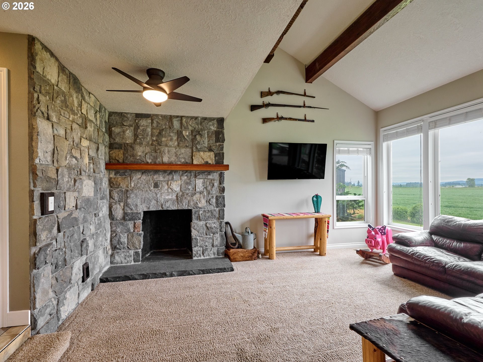 9293 Broadacres Road Northeast Aurora, OR 97002 - Photo 7 of 48 a living room with furniture a flat screen tv and a fireplace
