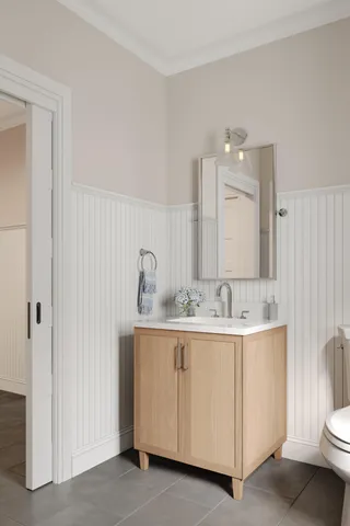 a bathroom with a double vanity sink and a mirror